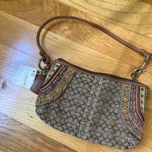 Small coach factory wristlet. Never used still has tags